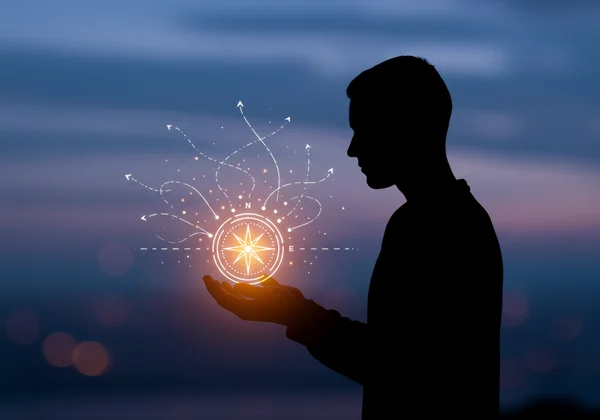 Person reflecting, holding a compass for self-discovery